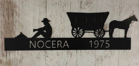 Rustic metal cowboy sign with cowboy and covered wagon