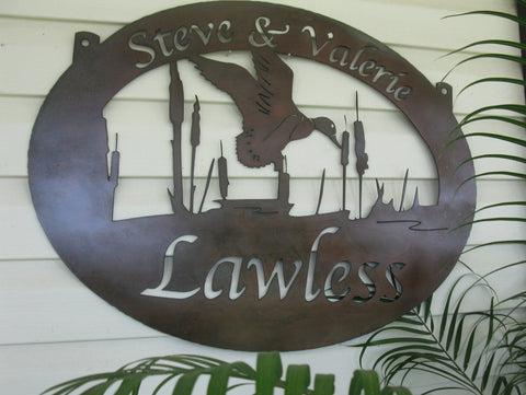 Metal sign with duck, cattail scene