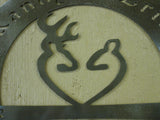 Metal sign with buck doe symbol