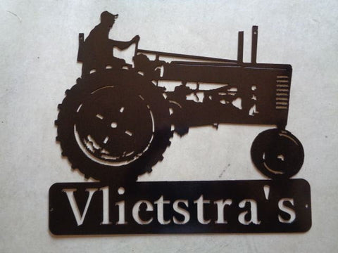 metal tractor sign with farmer on antique tractor