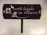 Metal garden sign, earth laughs in flowers